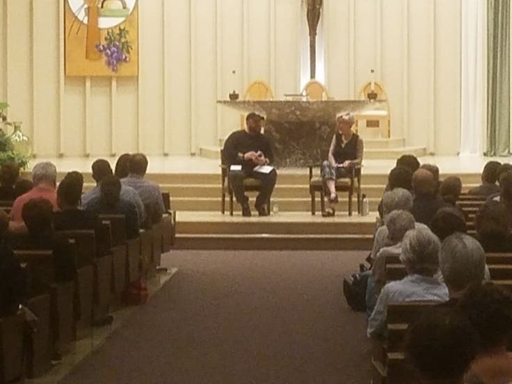 Neighborhood residents listen to Christian Picciolini and Nora Flanagan. 
