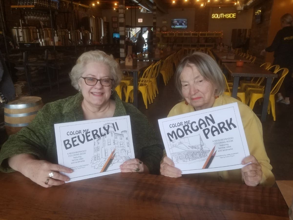 Carol Flynn (left) and Judie Anderson show off the covers of their latest neighborhood coloring books. 