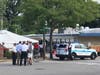 Chicago police officers talk to 19th Ward Ald. Matt O'Shea after a shooting killed one person and wounded five others outside the Lumes Pancake House in Morgan Park.