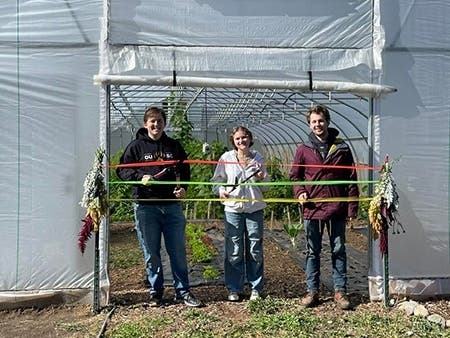 From left, OUSC Director of Sustainability Nick Skinner, President of Growing Grizzlies Audrey Hoffman and Student Farm Manager Shane Dawson at the ribbon-cutting event for the new "Salad Place" hoophouse.