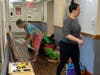Volunteers empty out the playroom to make room for new items