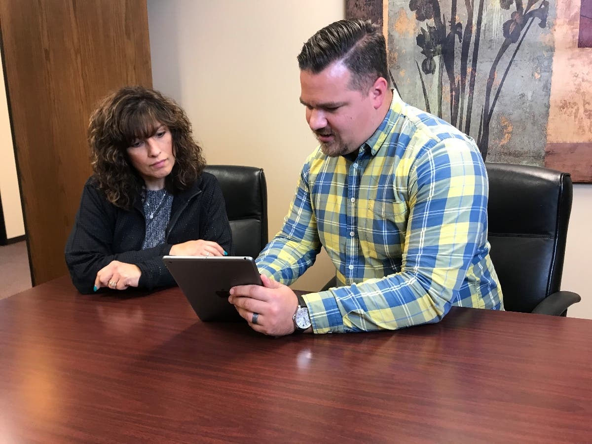 Jonathan Henkels works with a client at Phase 3 Advisory Services. This is Henkels' second career and was helped greatly through mentorship with the firm's founder John Bever.