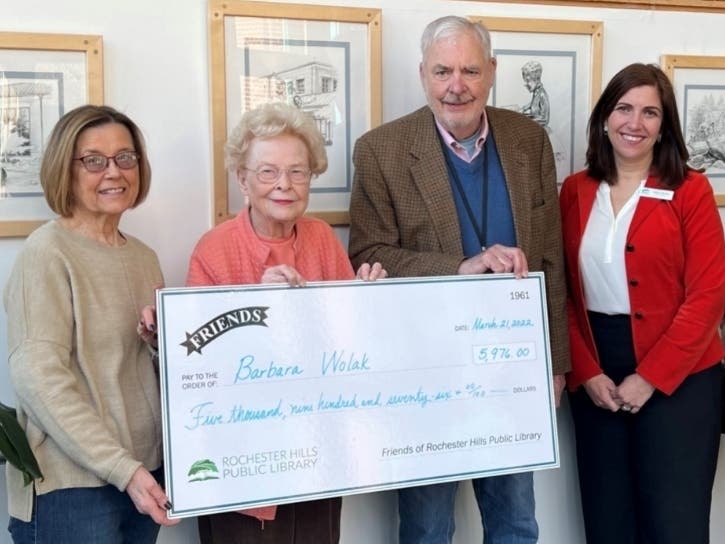 From left, Friends secretary Sandy Tabacchi, winner Barbara Wolak, Friends vice-president Bill Kroger and Library Director Juliane Morian present a giant version of the 61-39 winner’s check. 

