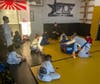 Defiris, back center, oversees his instructors in a class for his young students. 