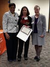 Theresa Cosmas accepting her award w/ Delaine Bailey, President of the YWCA Board of Directors, and Jan Lilien, YWCA CEO