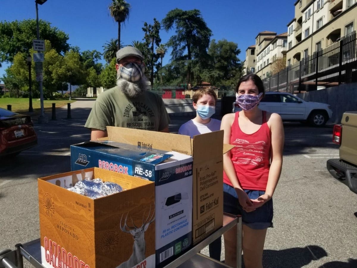 A family prepares to deliver hot meals to needy older adults