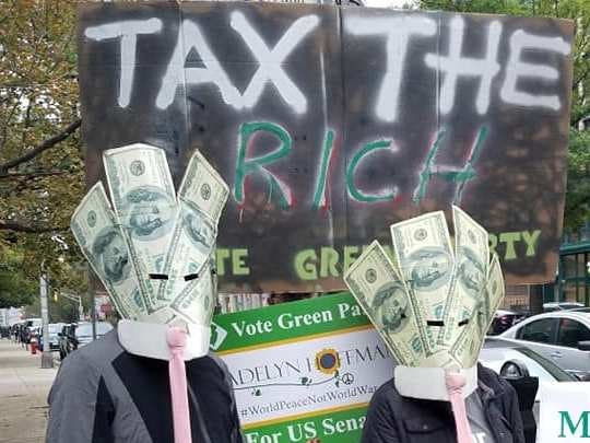 Protesters with the Green Party of New Jersey rally at a political fundraiser in Jersey City on Oct. 15, 2018.