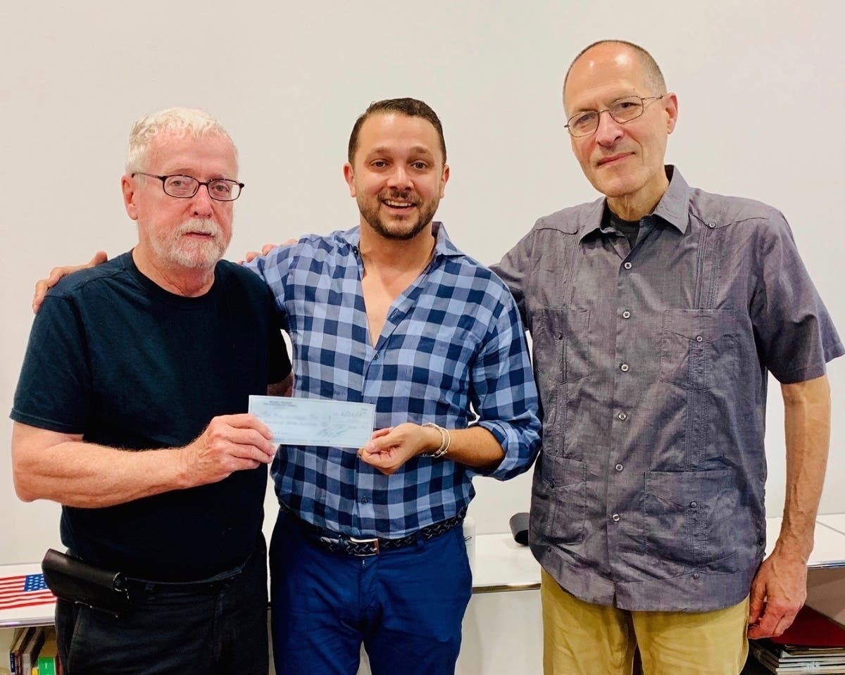 Hoboken Councilman Mike DeFusco, center, regifts a donation from Frank “Pupie” Raia to American Legion members.