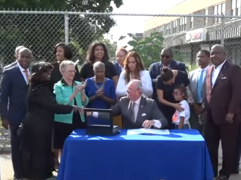 Gov. Phil Murphy signs legislation allowing municipal land banking in Newark, NJ on July 10, 2019.