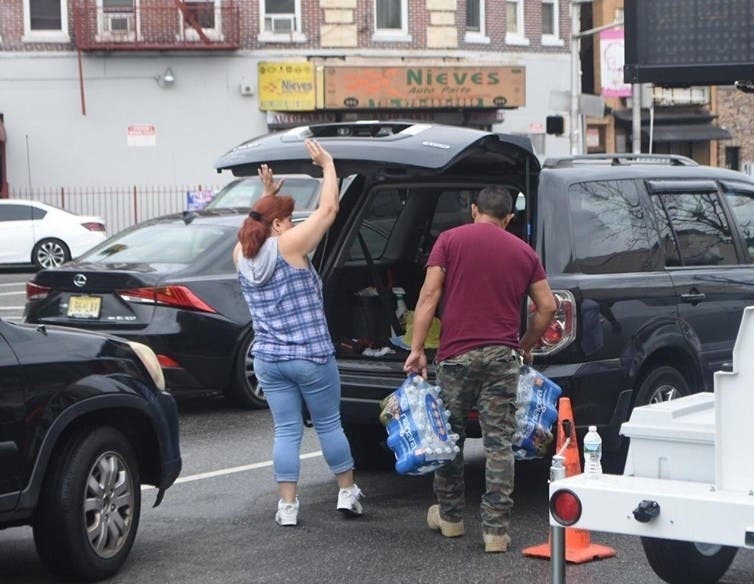 Newark residents pick up bottled water as the city continues to deal with lead contamination.