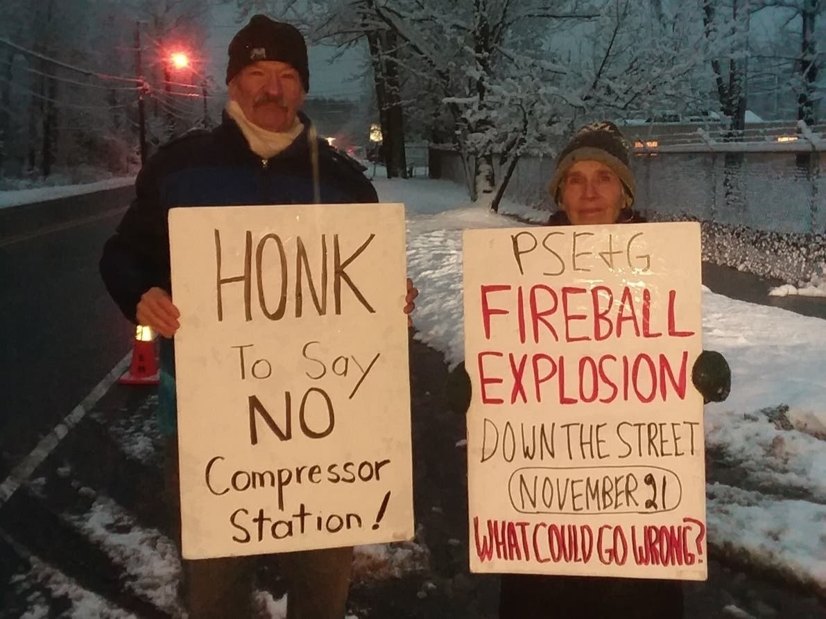 A pair of protesters rally outside a natural gas compressor station in Roseland, New Jersey on Dec. 2, 2019. 