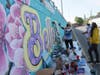 Local artist Athena Zhe and students paint a mural in Belleville, NJ.
