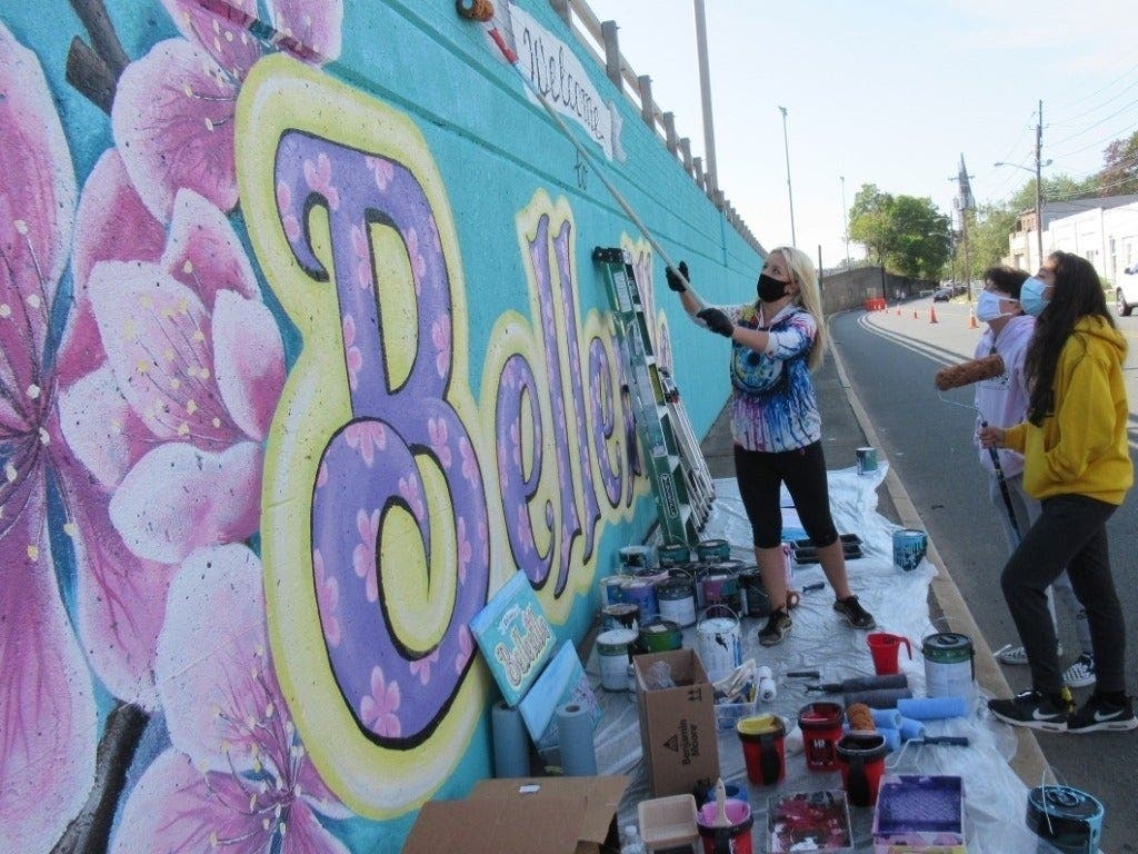 Local artist Athena Zhe and teen assistants create a mural in Belleville, NJ.