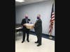 Dan Cipoletti gives Christopher Conklin a welcome basket from the Board of Education.