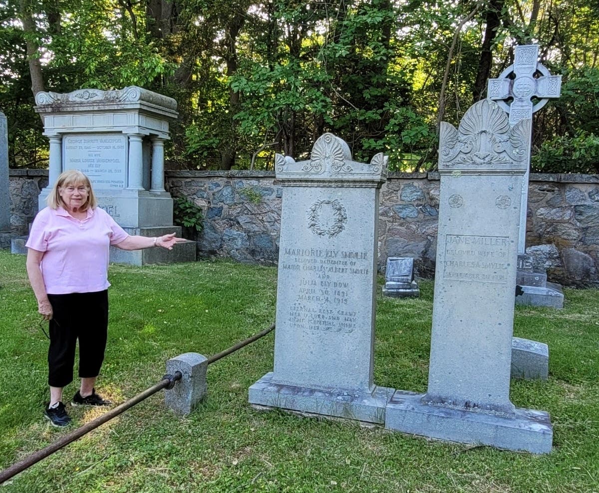 Arlene Newcomb, secretary of the Livingston Historical Society, looks at the graves of Marjorie Ely Smylie, daughter of Major Charles Albert Smylie and Julia Ely Dow, and of the actress and playwright Jane Miller, wife of Lt. Charles Albert Smylie.