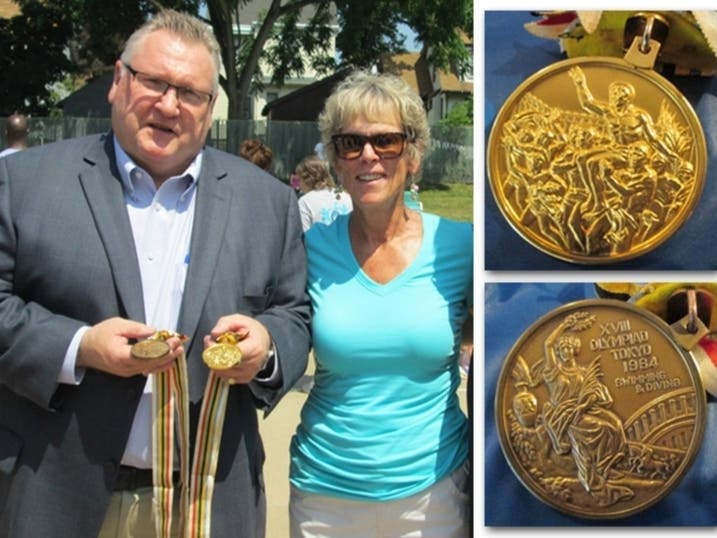 Joe Fagan stands next to Ginny Duenkel with her Olympic medals on July 12, 2014. Duenkel was honored at the pool that bears her name celebrating the 50th anniversary of her Olympic accomplishments.