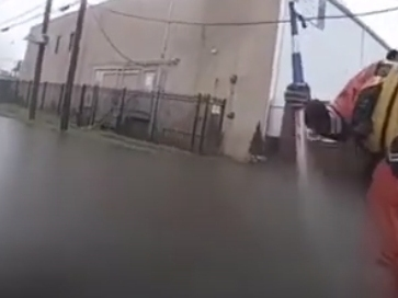 Newark first responders rescue a driver in flooded waters at Wilson Avenue and Avenue L in Newark on Sunday. Tropical Storm Henri also caused other damage and incidents in the city, officials said.