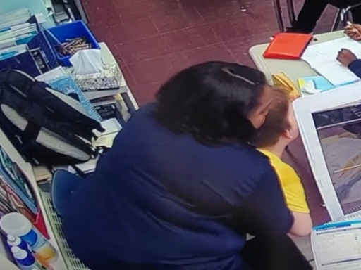 A teacher at East Orange Community Charter School in New Jersey rushes to a student's aid after he chokes on a water bottle cap on April 6, 2022.