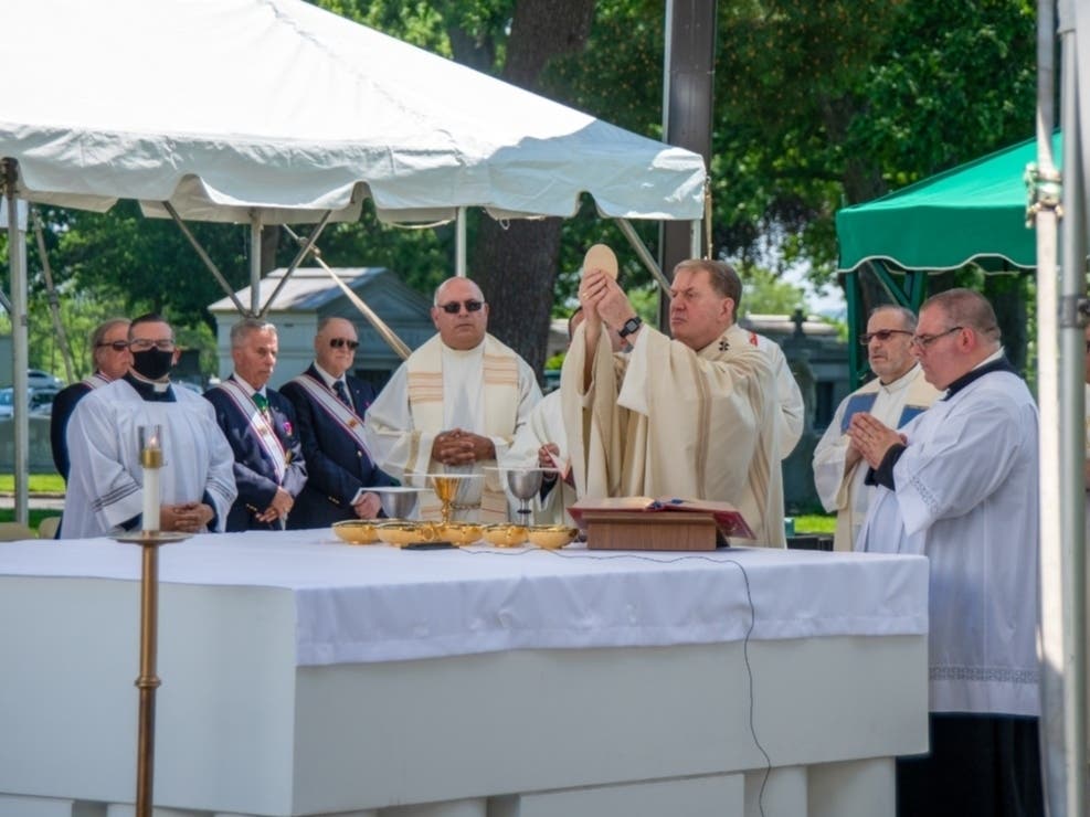 Cardinal Joseph Tobin consecrates the Eucharist during a Memorial Day Mass at Holy Cross Cemetery in North Arlington.