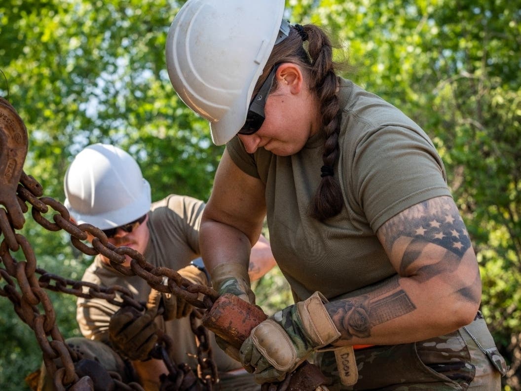 New Jersey National Guard soldiers secure a vehicle onto a rail car in Morrisville, Pa., May 15, 2023.