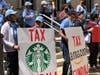New Jersey activists rally against plans to let the state's corporate business tax surcharge of 2.5% expire. Gov. Phil Murphy and other legislative leaders have said they plan to let the tax sunset at the end of 2023.