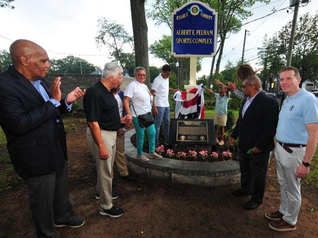 Essex County officials join members of Al Pelham’s family (from third from left) son-in-law Charles Fischer III, wife Audrey Pelham, grandchildren Charles IV and Cameron Fischer, and stepson Dwayne Jones, at a dedication ceremony on July 14.