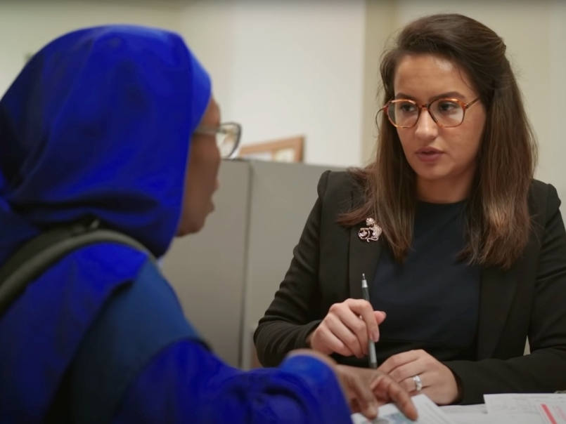 Legal assistant/program manager Zarlasht Stanakzai (right) assists a client at the Bishop Francis Center for Legal Immigration Services, a department within Catholic Charities of the Archdiocese of Newark that aids migrants and refugees.