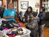 Mercy House Associate Director Pete Hernandez helps a family who recently arrived from Venezuela pick out warm weather clothes during the Archdiocese of Newark’s annual Winter Coat Giveaway at The Mercy House of Newark on October 17, 2023.