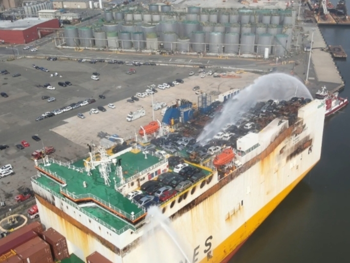 The motor vessel Grande Costa D’Avorio is shown from an unmanned aircraft systems perspective of firefighting efforts from a Unified Command in attempts to extinguish the fire aboard the ship at Port Newark, New Jersey, July 8, 2023.
