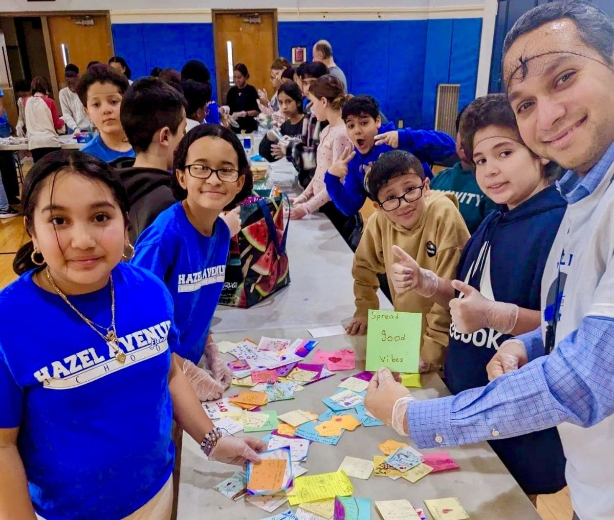 Students and staff from Hazel Elementary School roll up their sleeves and put together bag lunches for Christine's Kitchen, a local soup kitchen that provides meals every Saturday at Holy Trinity Episcopal Church in Essex County, NJ.