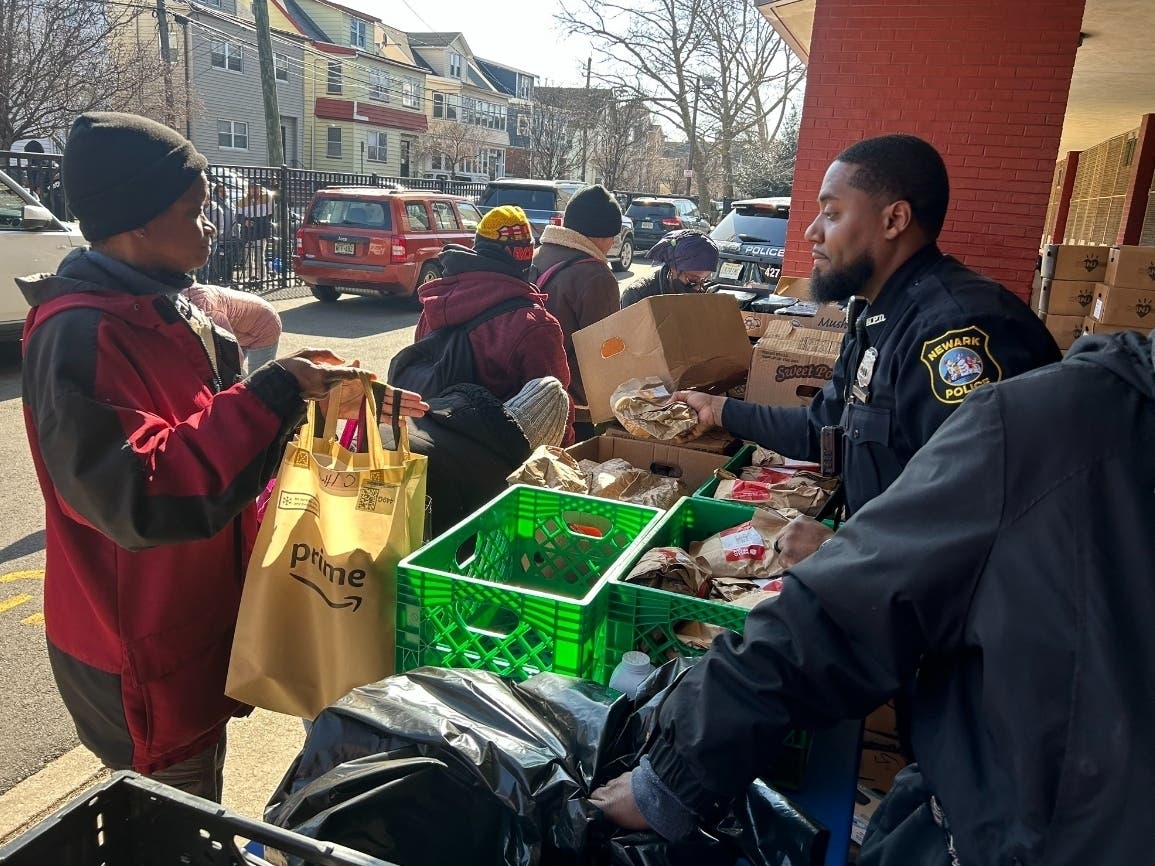 Newark police officers in the 4th Precinct joined staff at John F. Kennedy School staff for a community food drive on Feb. 9, handing out vegetables, poultry and other items to attendees.