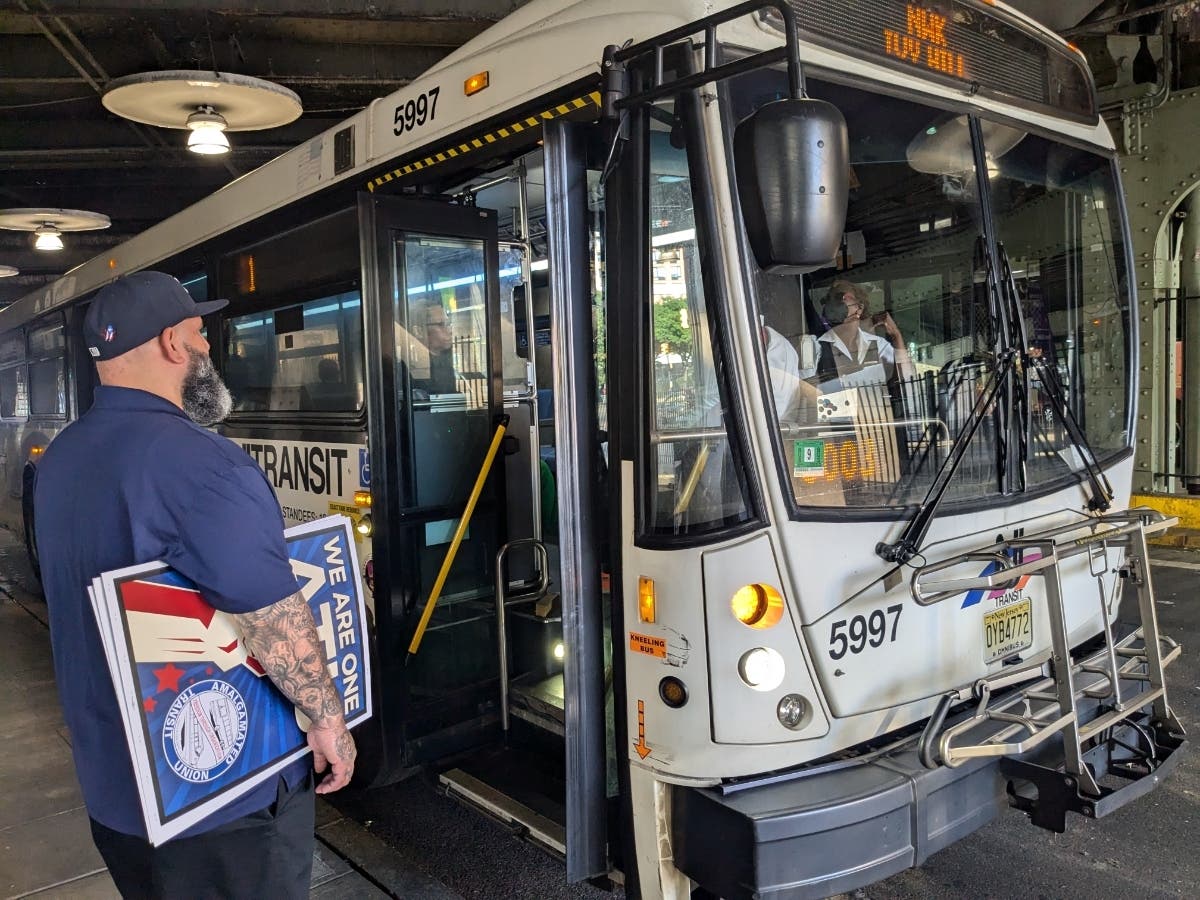 A proposal would roll out a 2.5 percent tax on businesses that earn more than $10 million per year in New Jersey. It would create a regular funding source for NJ Transit. Above, a supporter of the plan takes part in an action on June 25.