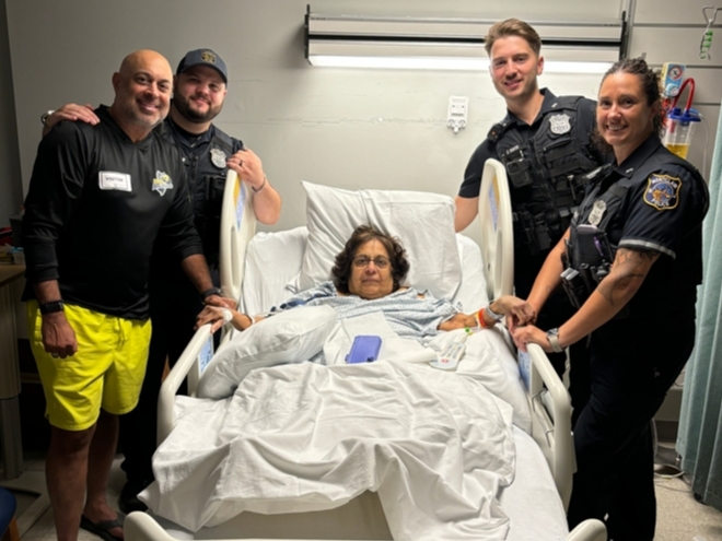Montclair police officers pose for a photo in the hospital with Devyani Shroff after responding to her home on a medical call.