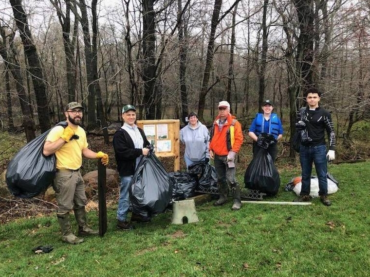 Mayor Al Anthony (second from left), participates in a Passaic River cleanup sponsored by the Livingston Trails & Greenways Committee.