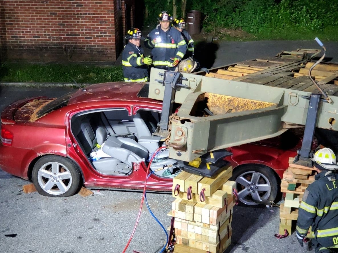 The Livingston Volunteer Fire Department conducts a vehicle extraction drill that simulates a car being pinned under a trailer.