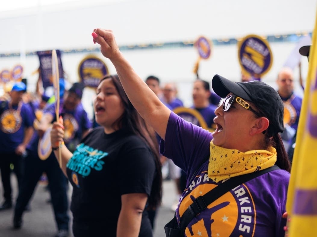 The Port Authority of New York and New Jersey, which runs Newark, JFK and LaGuardia airports, is proposing a new minimum wage policy for workers. Above, workers affiliated with labor union 32BJ SEIU rally to demand new work contracts in June 2024.