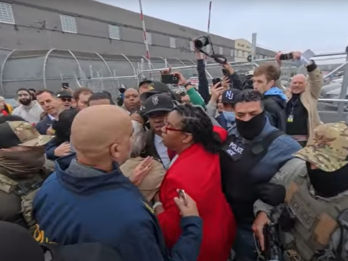 U.S. Rep. LaMonica McIver of New Jersey (seen in red jacket above) was recently charged in a three-count indictment in connection with an incident that took place outside Delaney Hall in Newark on May 9, 2025. 