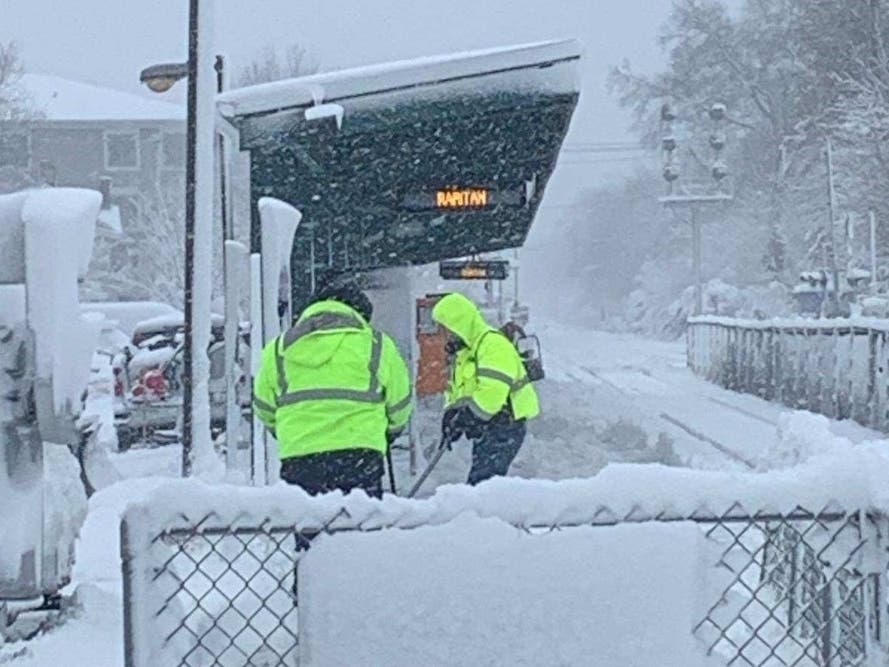 NJ Transit bus service and limited train service is expected to restart on Tuesday after a severe blizzard walloped the state last weekend. Above, a NJ Transit crew clears snow from a platform.