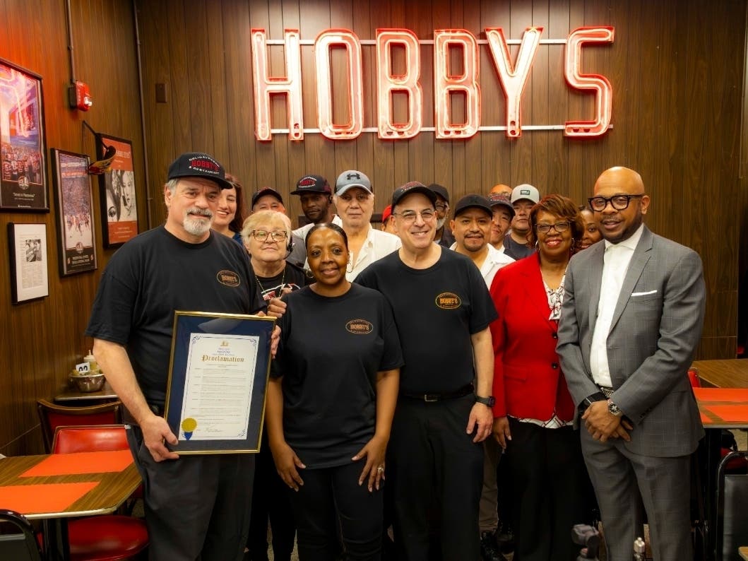 City officials present a proclamation in honor of Hobby’s Delicatessen and Restaurant to its owners on March 5, 2026.