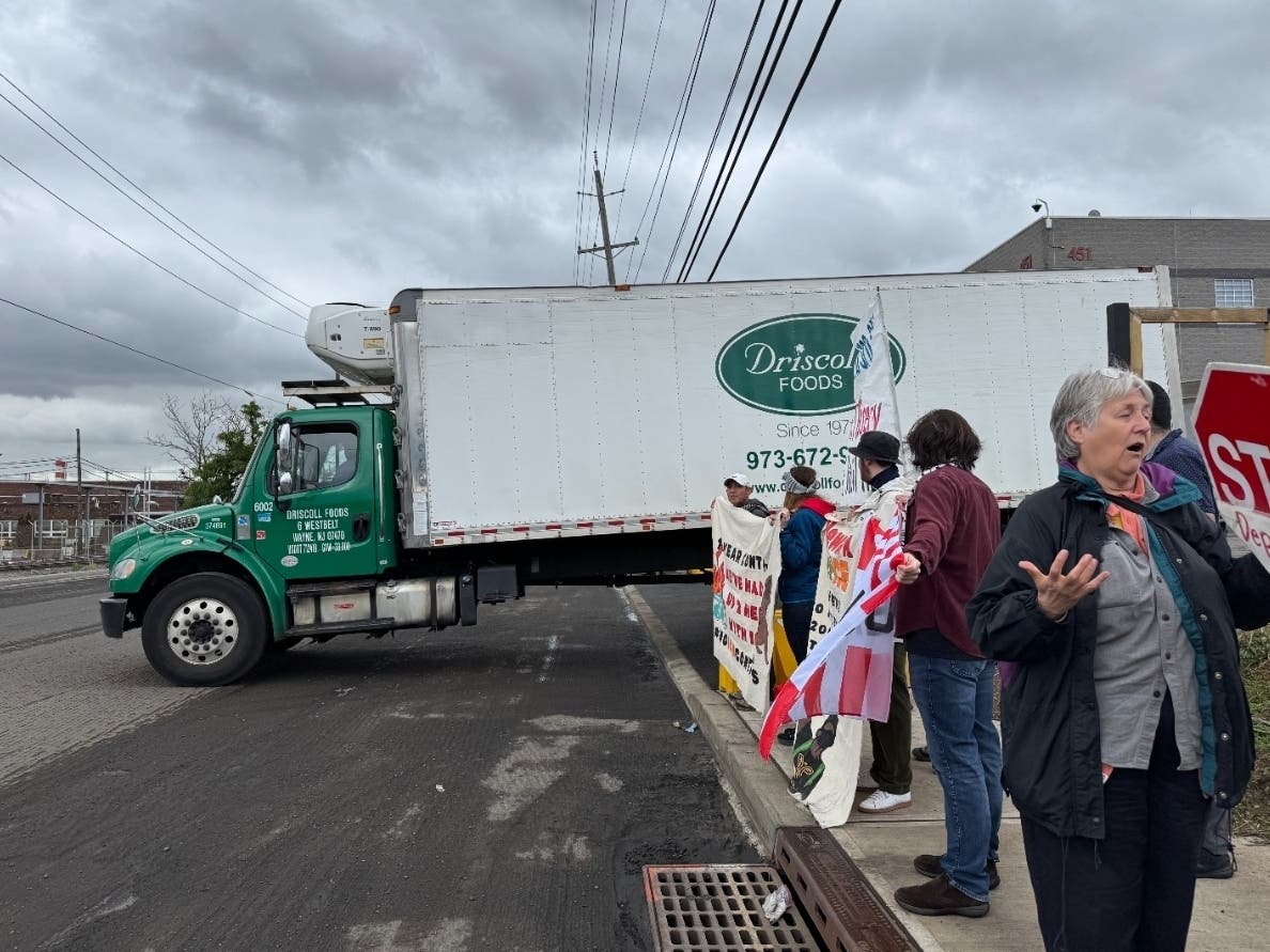 A Driscoll Foods truck is seen outside Delaney Hall in Newark, New Jersey as pro-immigration advocates rally nearby.