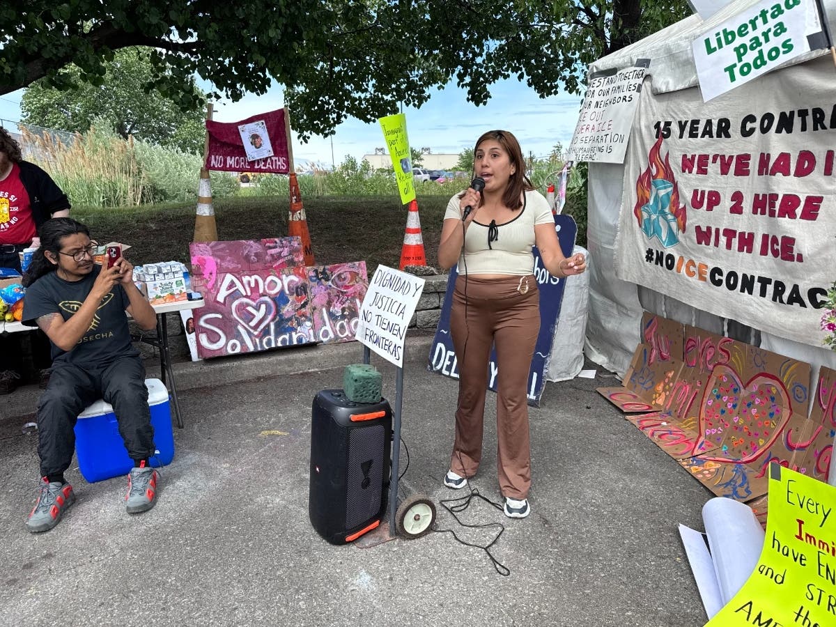 The wife of a detainee at Delaney Hall in Newark, NJ speaks on her husband's behalf during a rally outside the prison on May 22, 2026.