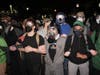 Protesters link arms and confront federal immigration officers outside Delaney Hall detention center Thursday, May 28, 2026, in Newark, N.J. 