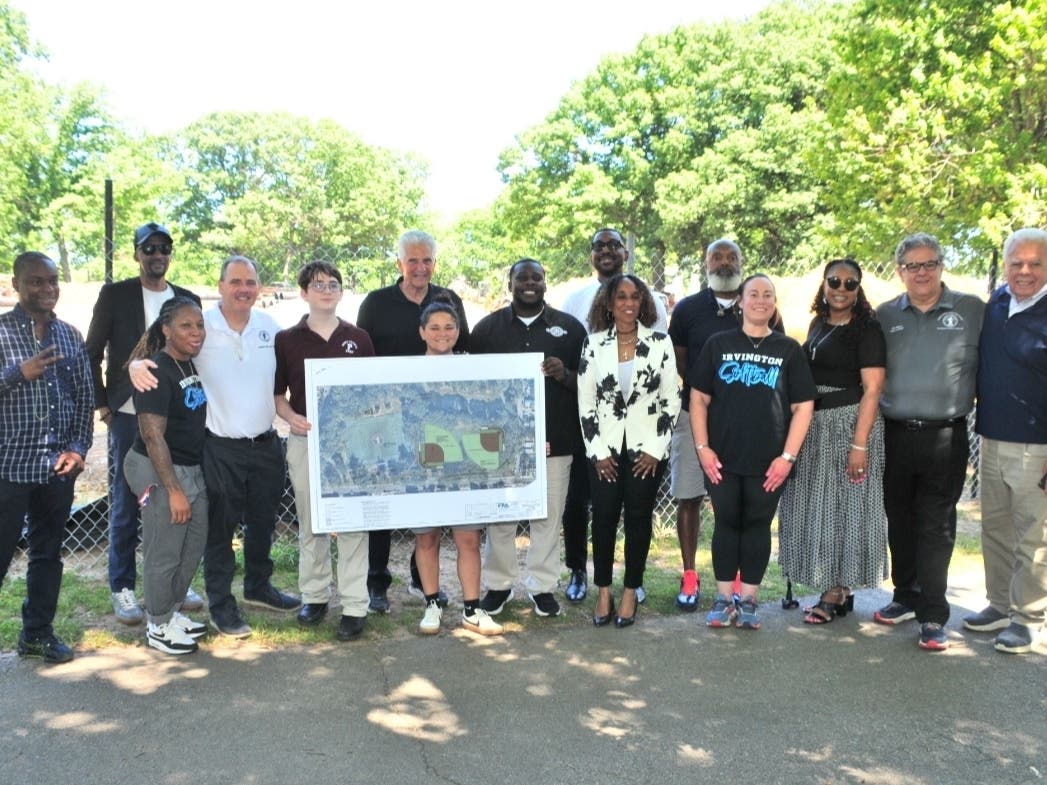 Essex County officials and community members gather at a news conference to announce plans to modernize the two softball fields in Irvington Park.