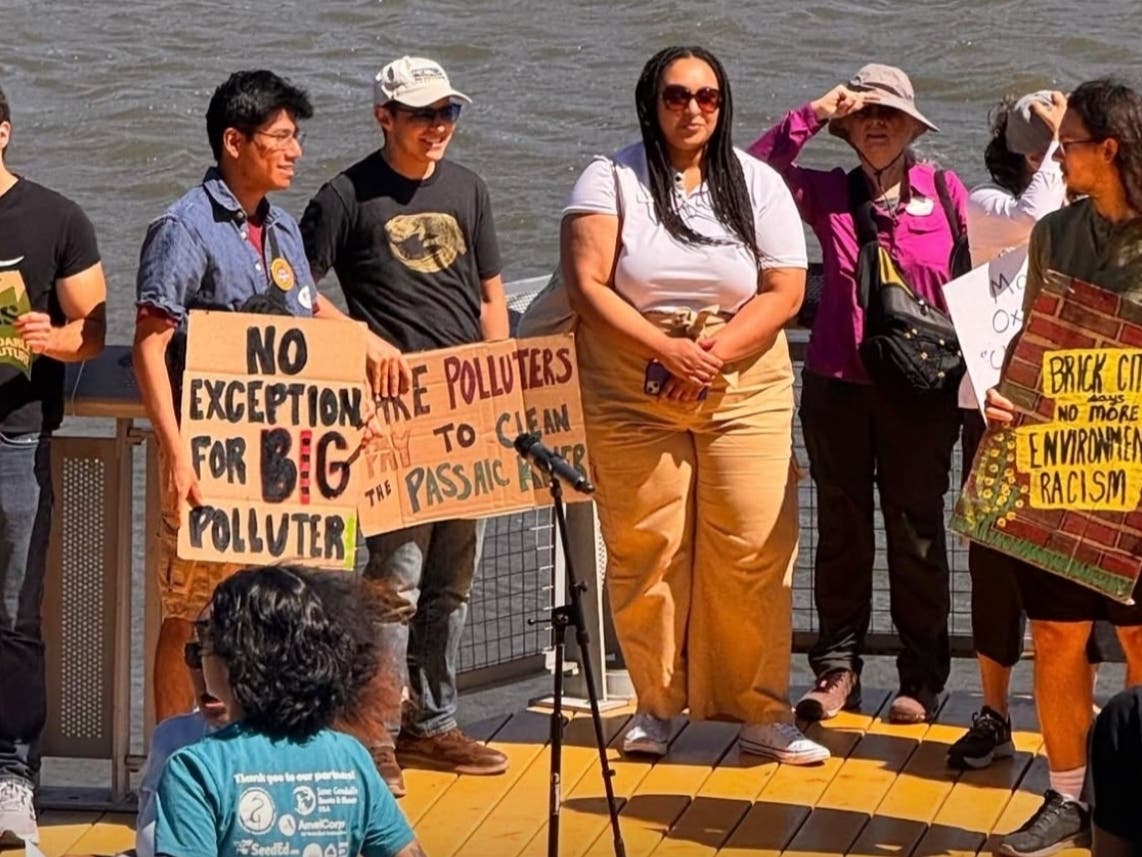 Activists with the Ironbound Community Corporation rally to demand cleanup of the Passaic River’s lower eight miles on June 20, 2026 at Riverfront Park in Newark, NJ.