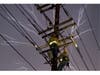 Heat lightning flashes as PSE&G workers restore a circuit near Patriots Stadium in Bridgewater, New Jersey on July 3, 2026 ahead of a severe summer storm.