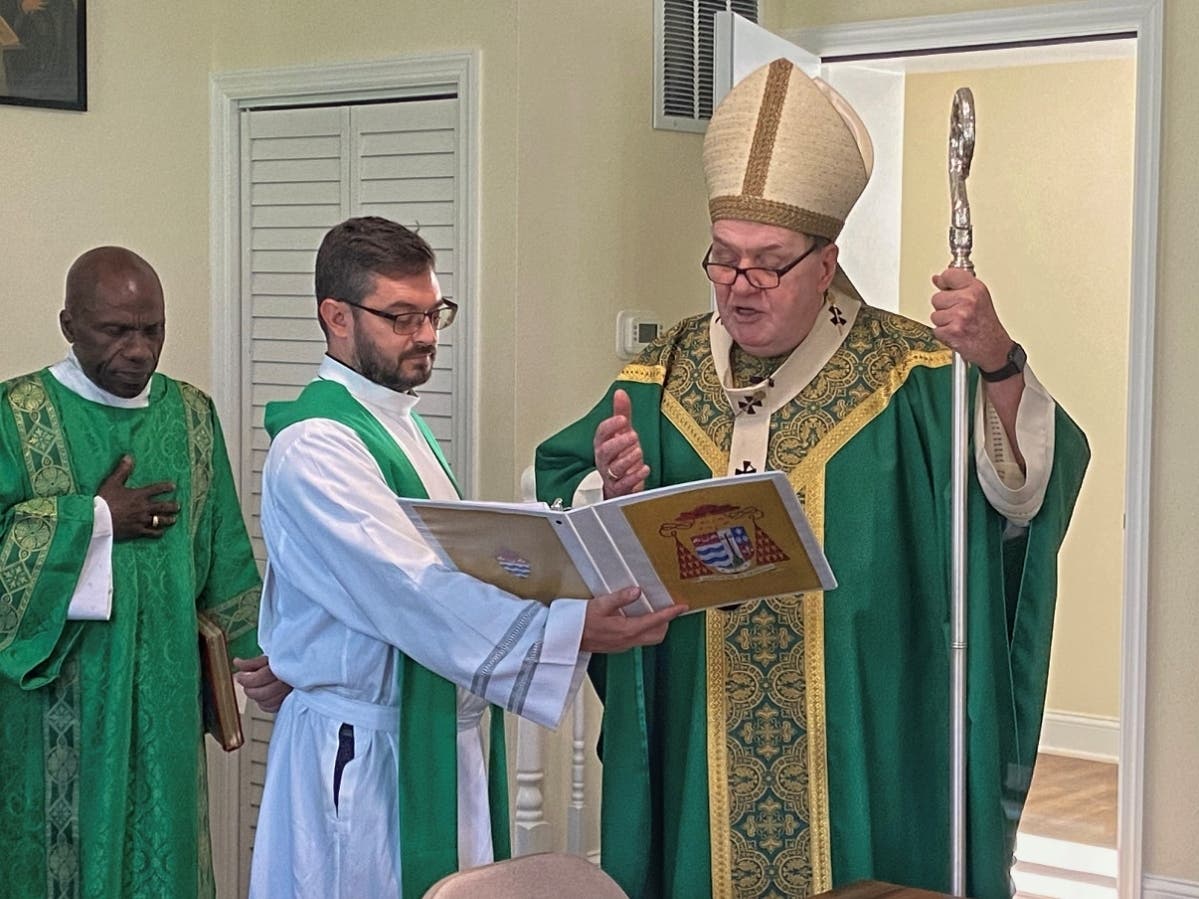 Cardinal Joseph Tobin blesses the rectory’s conference room with Father Anthony Palombo (center) and Father Chris Aleti, administrator of St. Lucy Parish (left).