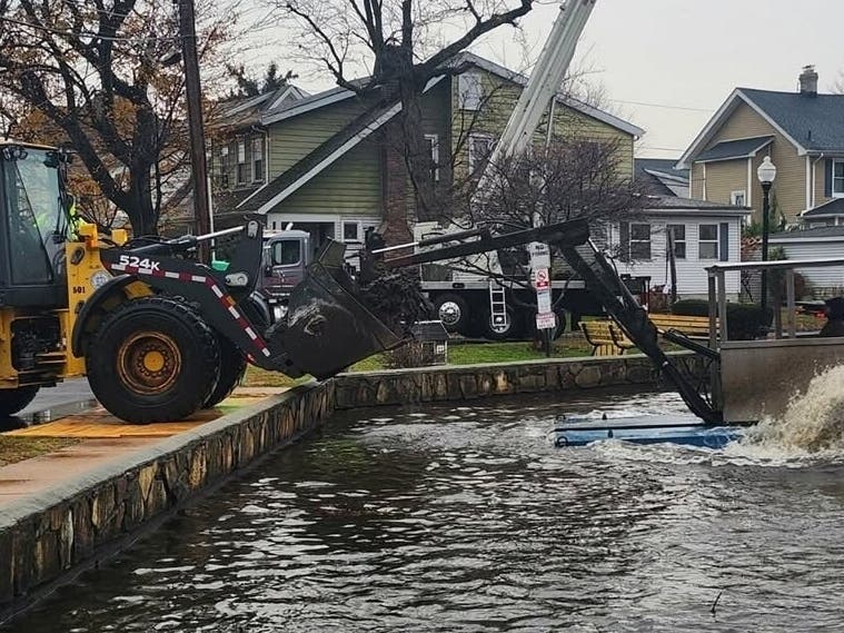 Workers use a hydro-rake to remove dirt and debris from Halcyon Pond in Bloomfield, NJ in February 2025.