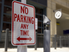 Above, a SafetyStick can be seen near a "No Parking" sign. The devices are equipped with cameras, which take photos of vehicles that park illegally in the area.