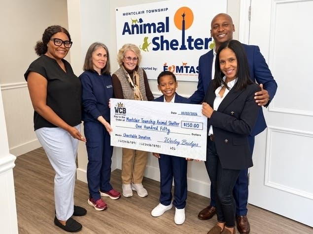 Wes Bridges and family present a check to the Montclair Animal Shelter. The funds were raised during a local car wash event, which also raised money for the Montclair Public Library.