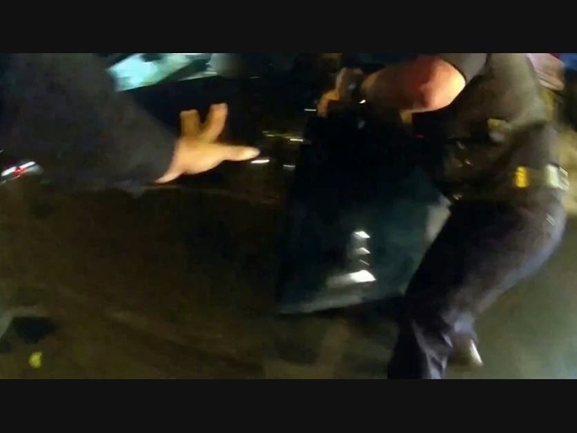 Police officers confront a man in a stolen vehicle on Aug. 12, 2024 in Newark, New Jersey.